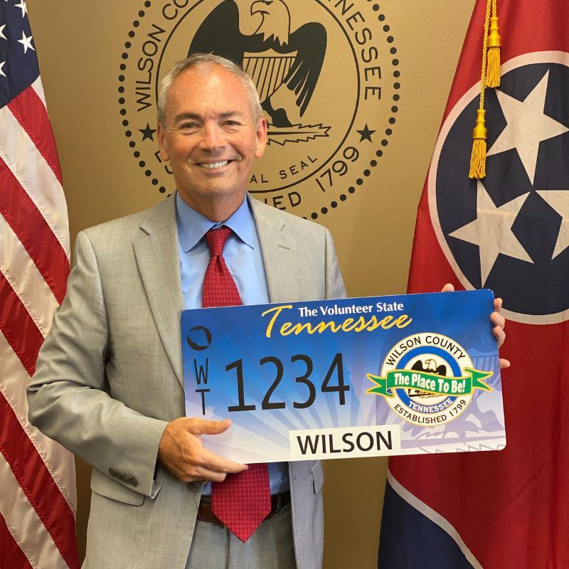 Mayor Hutto holding cutout of Wilson County Specialty License plate